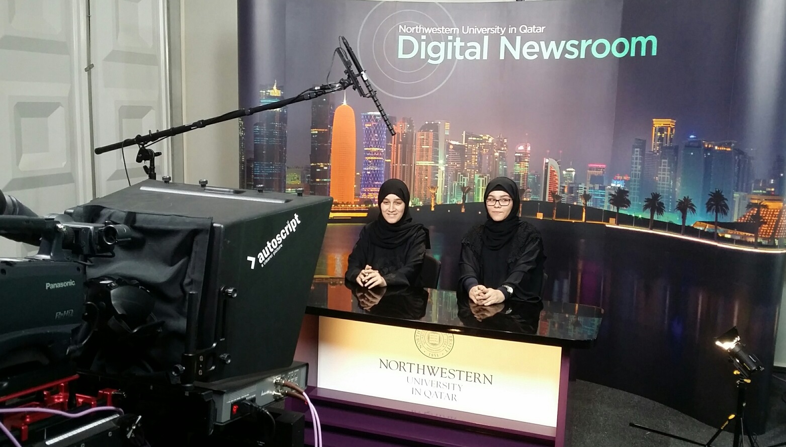 Local media enthusiasts, Safaa Mohammed Megdad and Hafsa Mekdad, take part in NU-Q’s interactive TV newsroom experience.
